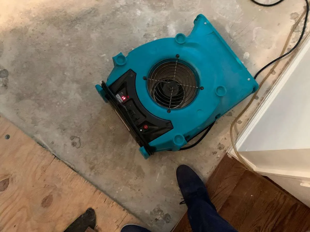 Air mover drying subfloor during Leak Detection & Repair in Emporia